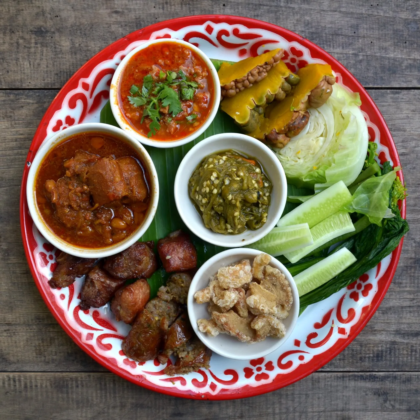 Thailändische Vorspeisenplatte mit Dips, Würstchen und rohem Gemüse
