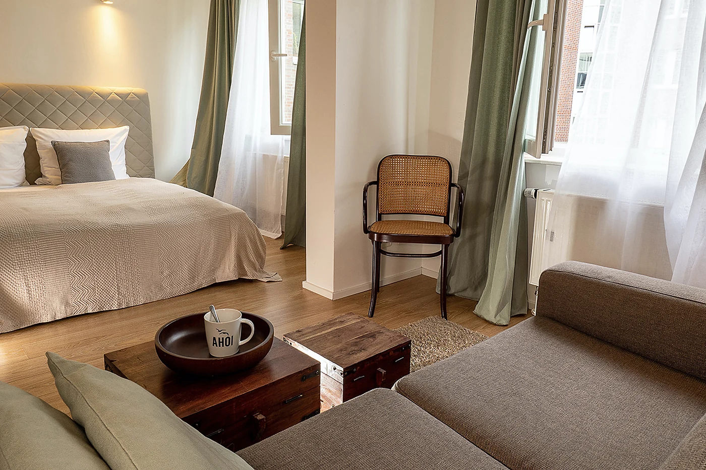 Apartment mit Bett, Sitzecke und niedrigem Tisch