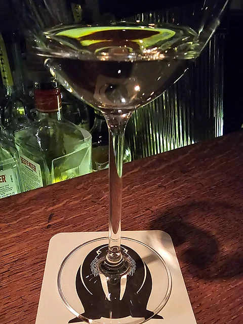 Cocktail im langstieligen Glas auf einem Untersetzer mit Walross-Logo der Walrus Bar